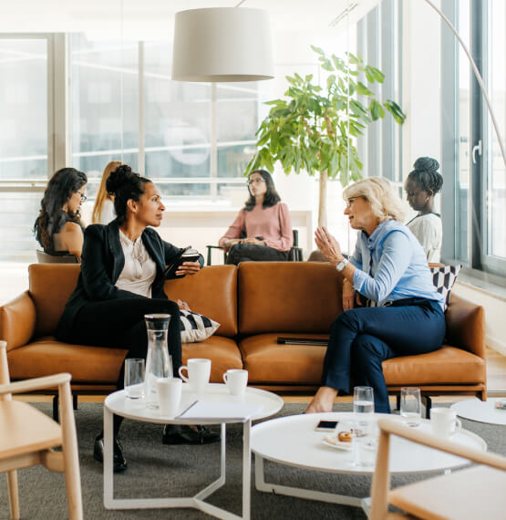 Businesswomen having a conversation on couch