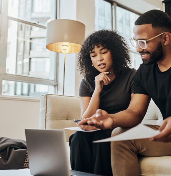 Two people using a laptop