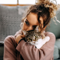 Woman hugging small cat