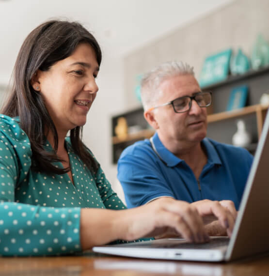 Mature couple using laptop