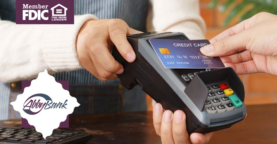 person paying with a credit card on a card terminal