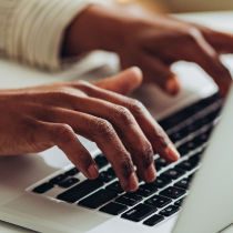 Hands typing on a keyboard