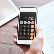 Hand holding phone showing calculator