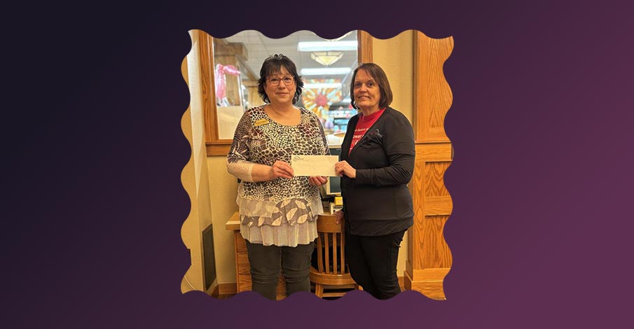 Karla Feldbruegge, Abbotsford Branch Manager posing for picture with Colby Library director holding a check from the AbbyBank Foundation Spring 2025 grant cycle
