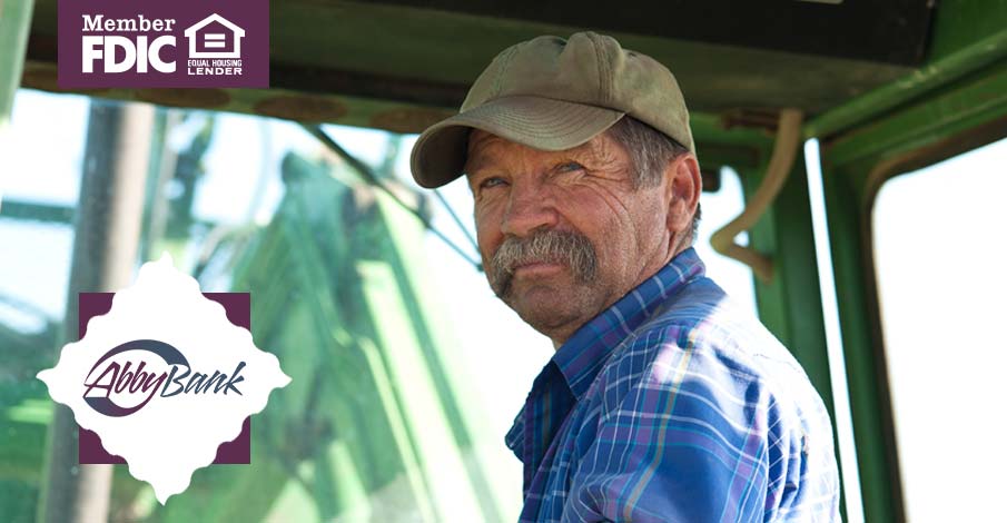 older farmer in tractor doing field work