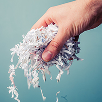hand holding shredded paper