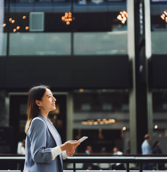 Businesswoman using mobile phone on walk