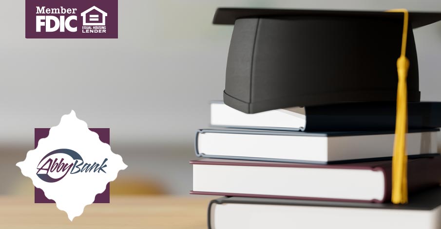 stack of books with graduation cap and tassel on top