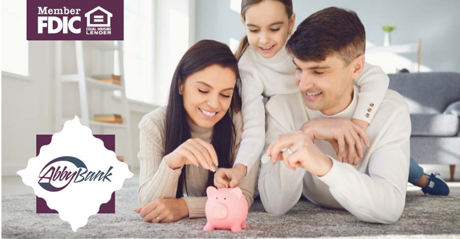 parents and young teen daughter putting money in a piggy bank together