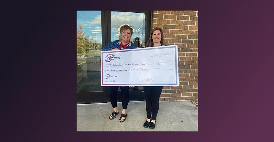 image of check presentation to Red River Riders for AbbyBank Foundation grant on a dark purple gradient background