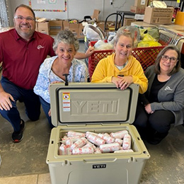 Gresham staff posing with Flo'ing with Kindness staff and cooler at Fair Animal Donation in 2023