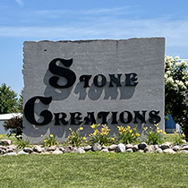 large stone sign saying "Stone Creations" with landscaping around for Stone Creations in Shawano, WI
