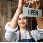 Business owner with "open" sign