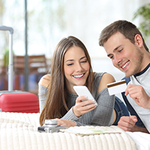 young travelers with card and phone