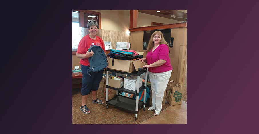 Sally Barwick with Grace United Church of Christ in Wausau poses with Jenelle Thompson, Wausau AbbyBank Branch Manager with a large collection of packpacks and other school supplies 