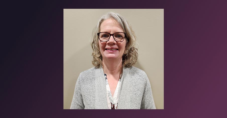 headshot of Tracy Hogden, Internal Auditor for AbbyBank, on a gradient purplish black background