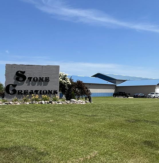 Stone Creations building in Shawano, WI area with large stone sign out front saying "Stone Creations" 