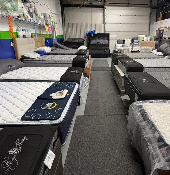 rows of new beds and mattresses at BoxDrop Mattress & Furniture Direct