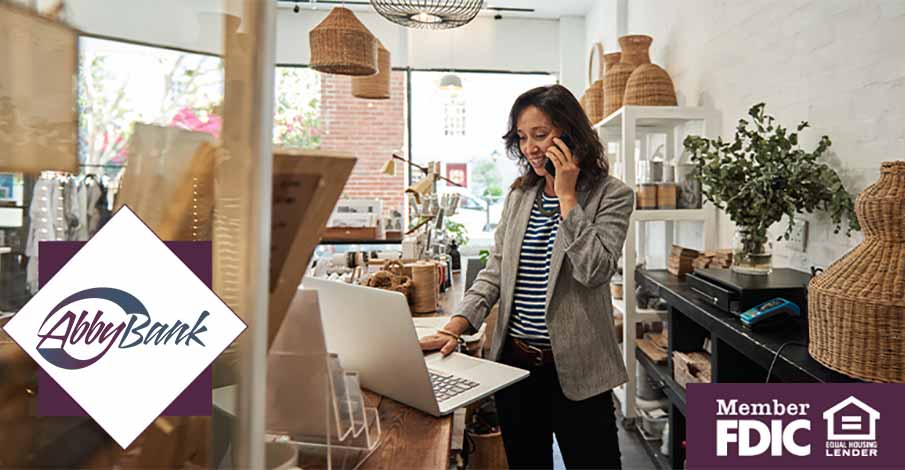 young business woman talking on phone and using laptop