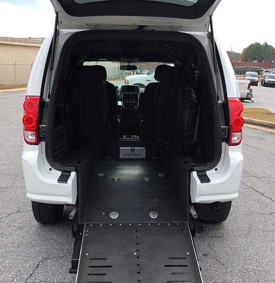 handicap accessible van with back hatch door open showing open ramp to get into van