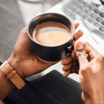 Hand holding coffee mug