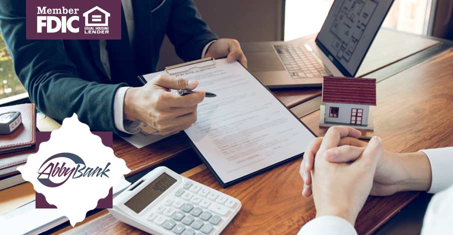 person talking with someone about house plans with form and calculator