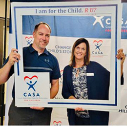 AbbyBank employees in Appleton posing in a square photo frame at a CASA event